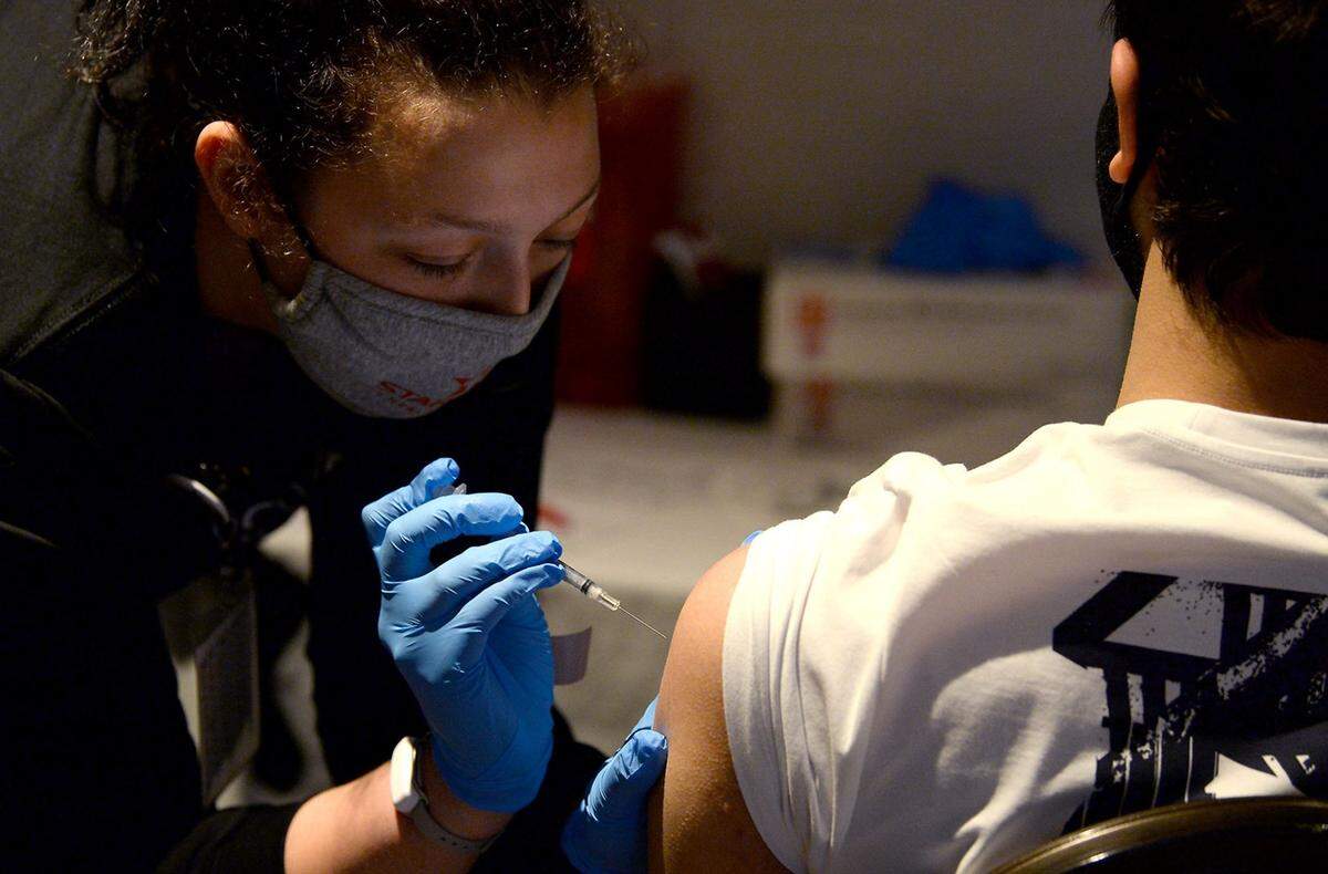 A medical worker administers a COVID vaccine in Charlotte, NC