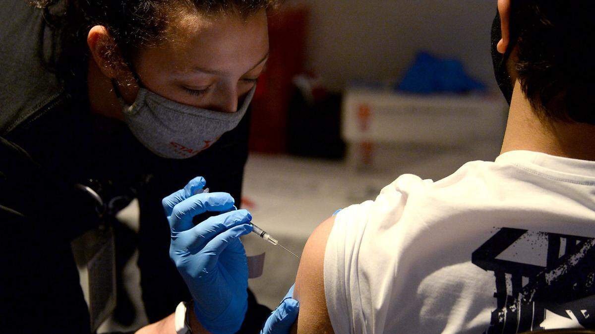 A medical worker administers a COVID vaccine in Charlotte, N.C.