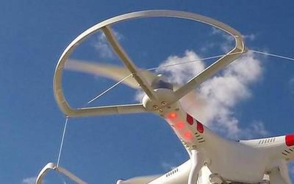 
An aerial drone with a small gimbal-mounted video camera. 
