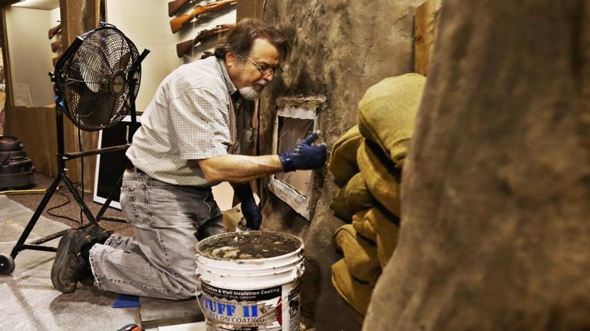 N.C. Museum of History exhibit artist Robert Stone adds the finishing touches to an exhibit case inside a fabricated trench for the exhibit "North Carolina & World War I," on Monday, March 27, 2017. Work for the trenches began last September. The 6,500-square-foot exhibit will be opening on Saturday, April 8, at the N.C. Museum of History.