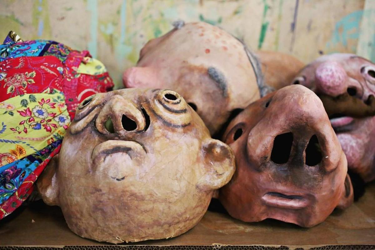 Several handmade masks are placed on a bench during rehearsal Thursday evening, July 20, 2017, in Saxapahaw for Paperhand Puppet Intervention's upcoming production “Of Wings and Feet.”