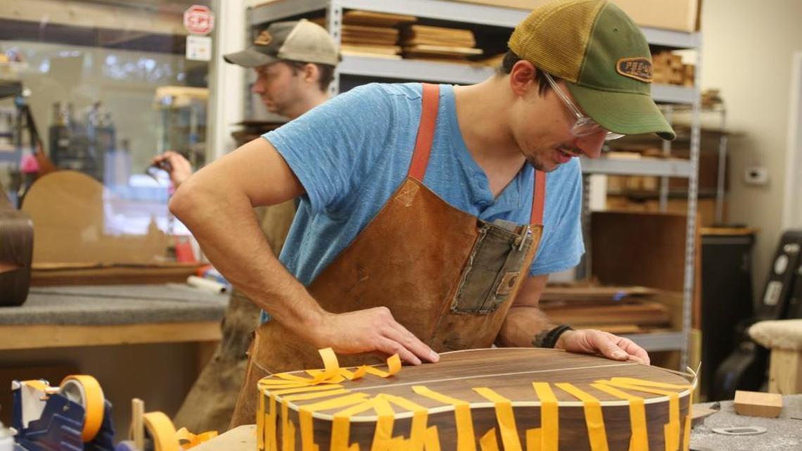 Ben Maschal, co-owner and luthier at Pre-war Guitars Co. in Hillsborough works on a guitar in the shop Tuesday, July 11, 2017. Maschal and business partner and luthier, Wes Lambe, "recreate the tone, feel and look of the Pre-War era while accommodating the needs of the modern musician" through their guitars.