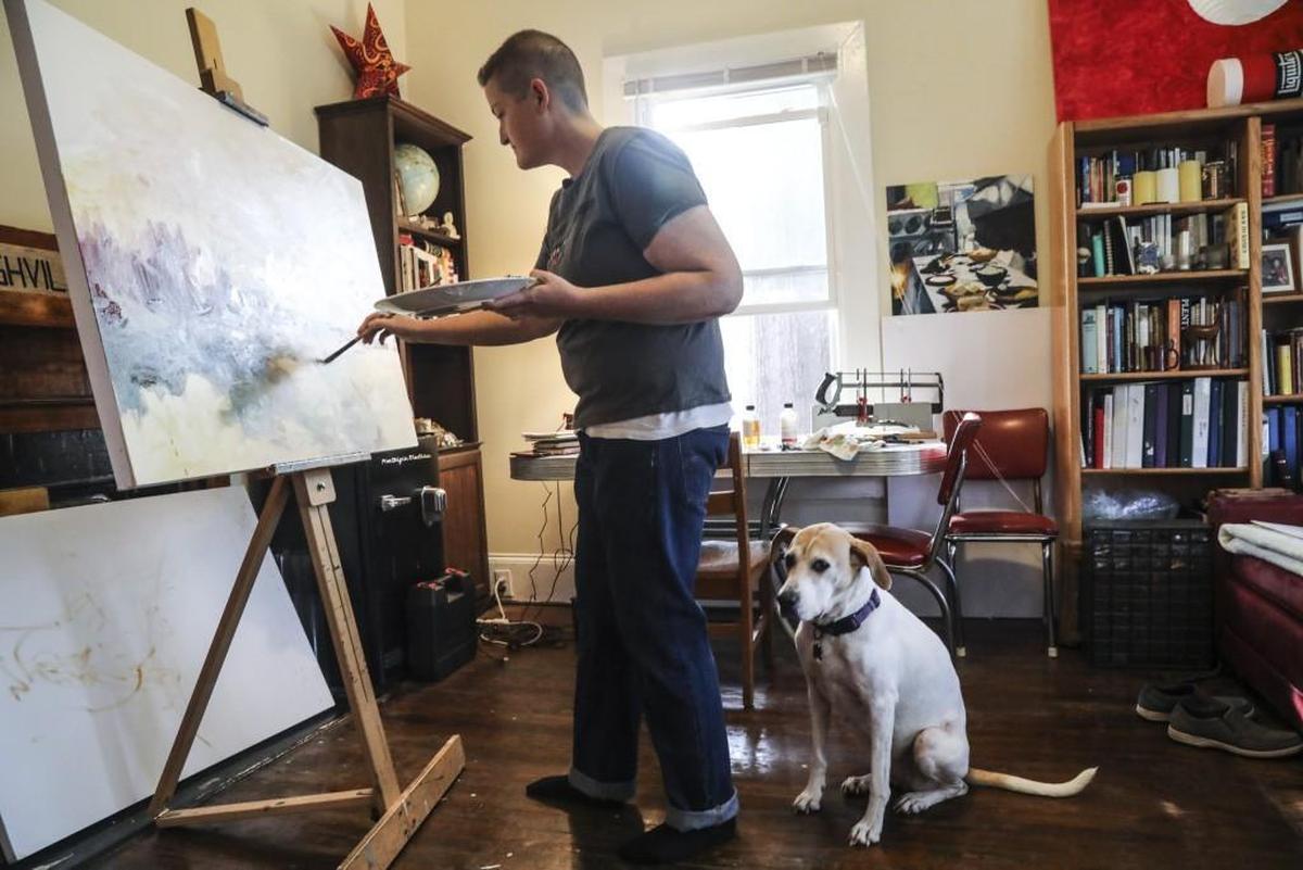 Painter Seraphim Smith works in his Kinston home studio Friday, Nov. 17. Kinston is emerging as an unlikely arts hub, thanks to a benefactor who attracts artists to the Eastern North Carolina town by renting them houses at affordable prices.