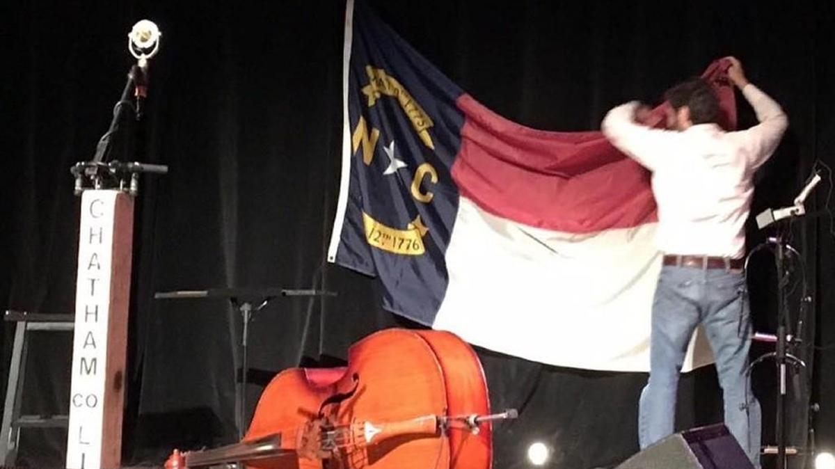 Chatham County Line’s Dave Wilson takes down the flag.
