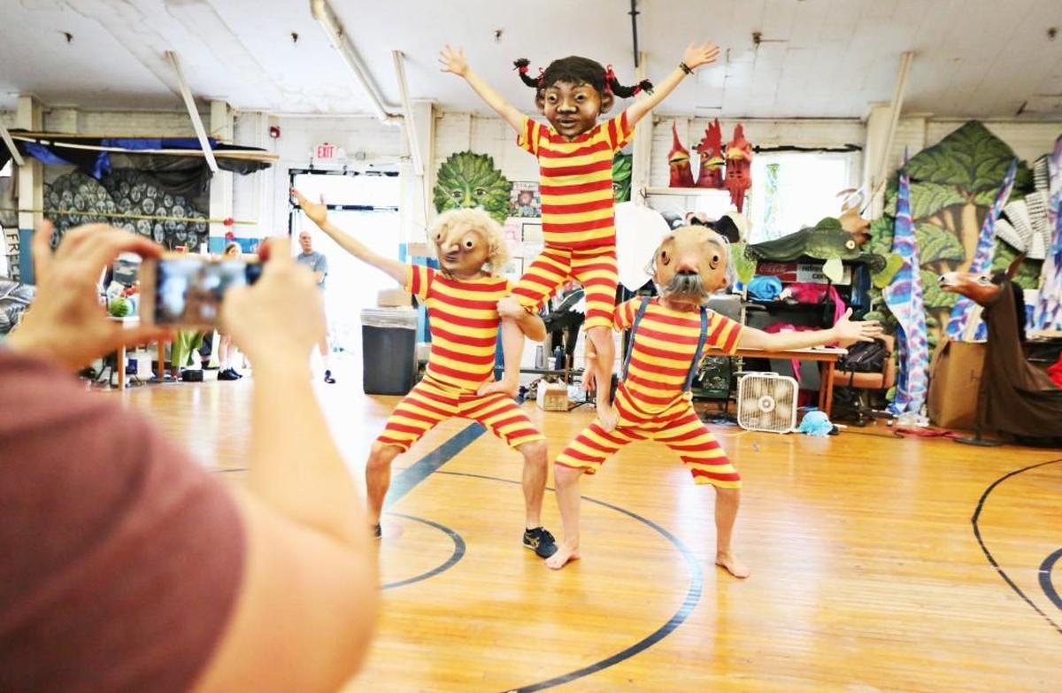 A photo is taken of the acrobats from left Tommy Noonan, Zella Magoo and Jimmy Magoo during rehearsal Thursday evening, July 20, 2017, in Saxapahaw for Paperhand Puppet Intervention's upcoming production “Of Wings and Feet.”