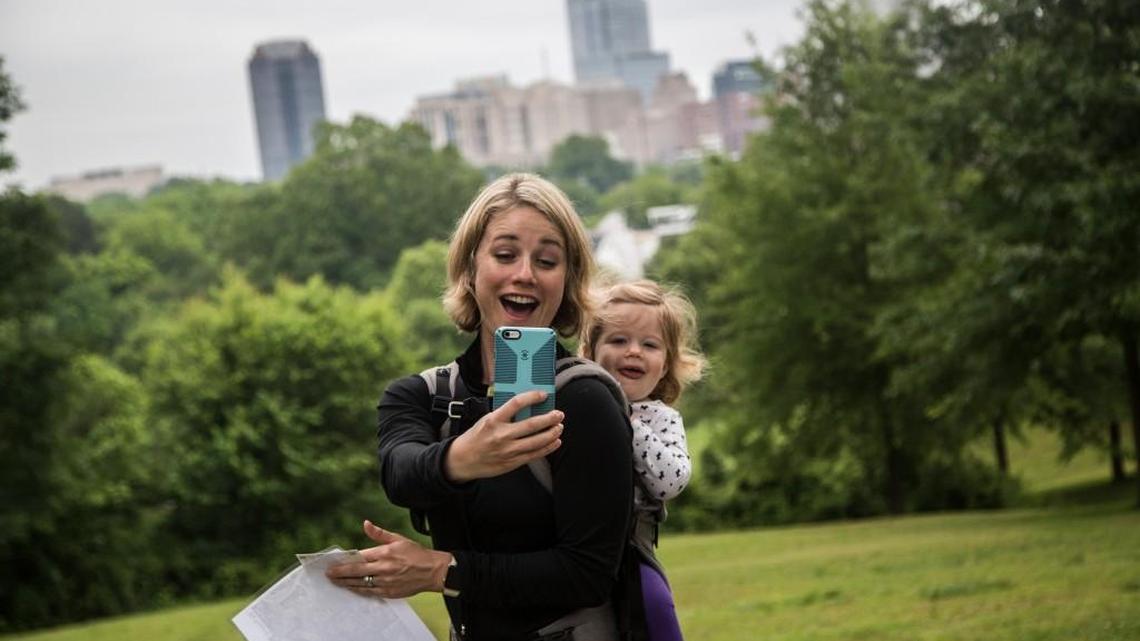 Jennifer Hoverstad, a parks and recreation board member, makes a photograph with her daughter Elin of the Raleigh skyline during a weekly guided tour of Dix Park Wednesday, May 18, 2016. Six teams of landscape architects are vying for the chance to remake the Dorothea Dix grounds into a destination park.