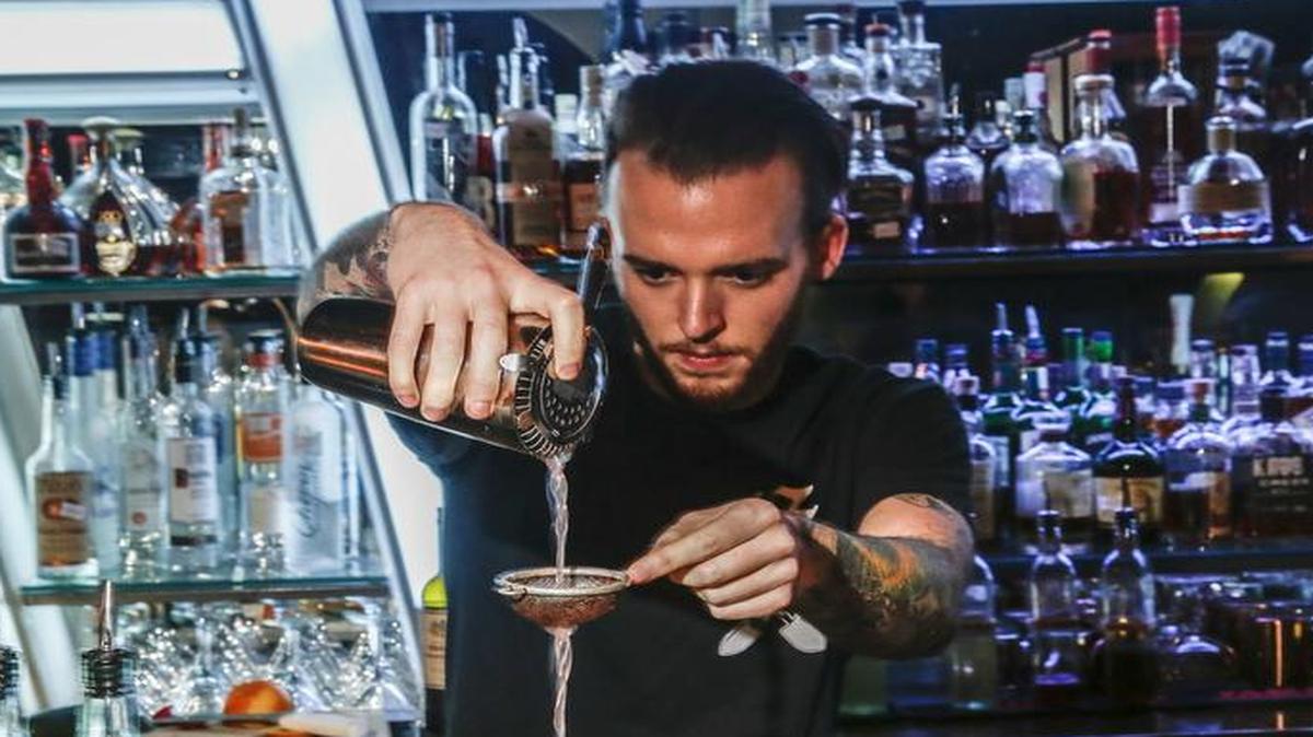 
Richie Cook serves cocktails Sunday, April 26, 2015 at Common 414 in downtown Raleigh. The upscale roaring 20s-themed cocktail bar features jazz and swing bands and the occasional burlesque show.
