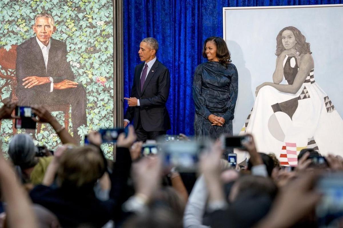 Former President Barack Obama and former first lady Michelle Obama stand on stage together as their official portraits are unveiled at a ceremony at the Smithsonian’s National Portrait Gallery, Monday, Feb. 12, 2018, in Washington. Barack Obama’s portrait was painted by artist Kehinde Wiley, and Michelle Obama’s portrait was painted by artist Amy Sherald.
