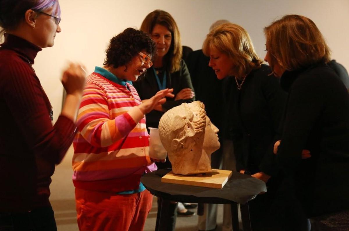 Noelle Ocon, left center, the conservator of paintings at North Carolina Museum of Art, answers questions about the head that was once attached to the Statue of Bacchus during a media preview at the museum Tuesday, Jan. 9, 2018.