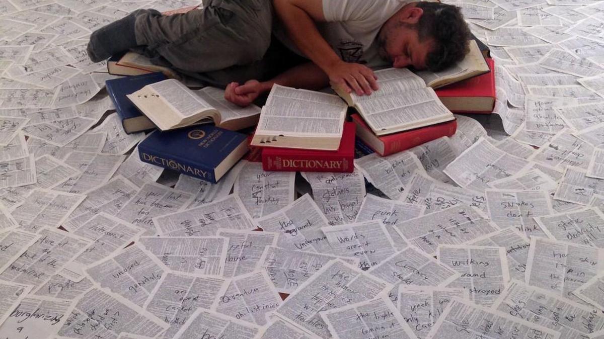 Chris Vitiello, a Durham author, is using Kickstarter to fund his ambitious performance-poetry installation “The Language Is Asleep.” In “The Language Is Asleep,” Vitiello appears as “sleeping writer,” scrawling poetry on dictionary pages.