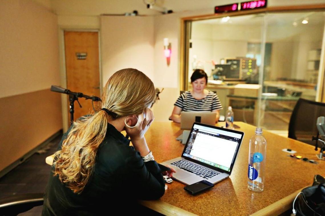 Phoebe Judge, left, the host and co-creator of the "Criminal" podcast, talks over upcoming stories with Lauren Spohrer, her co-creator of the podcast, after she records an ad for the show in a studio at WUNC in Chapel Hill Thursday, June 22, 2017.