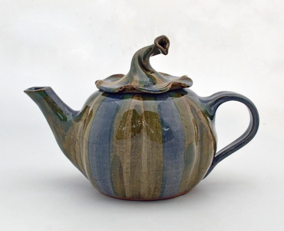 Bayle Owens created a pumpkin-shaped teapot with blue, green and gray stripes. The teapot’s lid mimics the greenery found at the top of the squash plant.