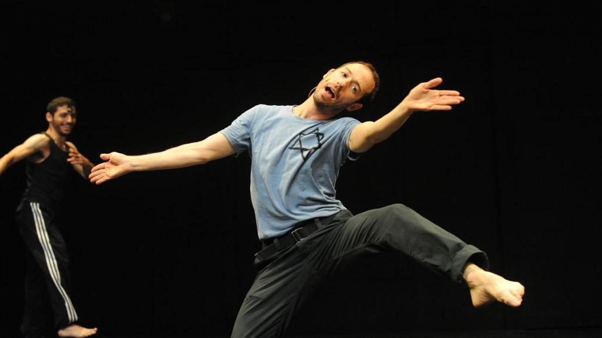 Hillel Kogan dances in a performance of “We Love Arabs,” a two-person show he wrote and stars in alongside Adi Boutrous, left.