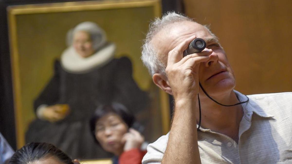 
Kilof Legge of Washington, D.C., uses a monocular to examine the painting "The Dancing couple" by Dutch artist Jan Steen during the "Picture This" tour for blind and low-vision visitors at the National Gallery of Art in Washington. The museum’s tours provide verbal descriptions for visitors once or twice a month.
