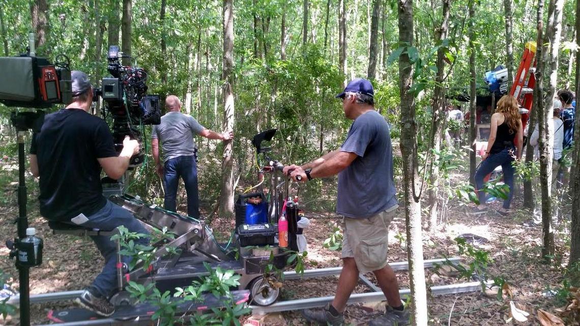 Rick Davidson, left and Scott Frye, both of Wilmington, operate the camera for the filming of a scene in the eighth episode of Under the Dome’s third season, while Dean Norris and Rachel Lafevre act in the scene.