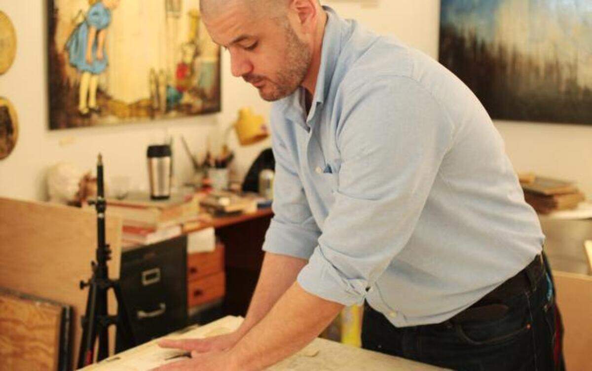 
Raleigh artist Ollie Wagner in his ArtSpace studio Tuesday morning, April 21, 2015. Wagner finds inspiration from old books, magazines and his latest flea market finds to create his layered collages.
