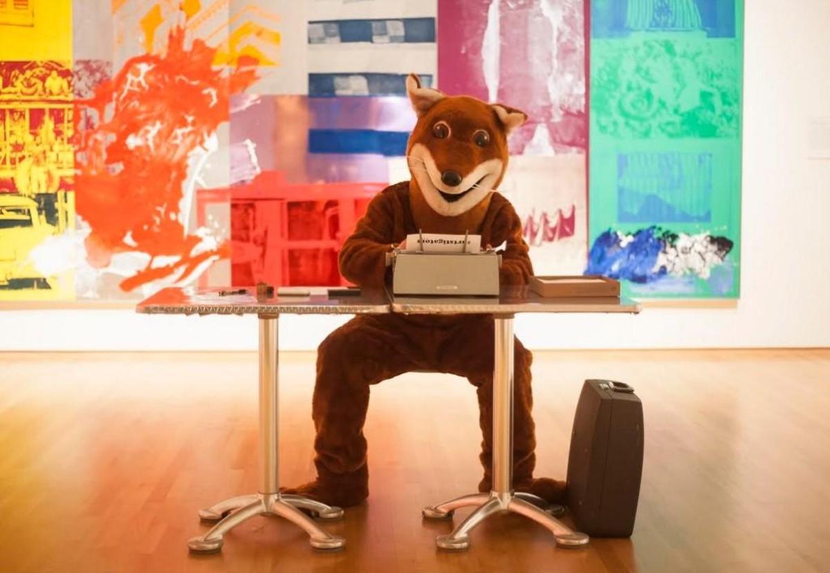 Chris Vitiello dresses as the Poetry Fox, a street poet. Vitiello, wearing a fox costume, sits at a typewriter and composes poems for people on request.