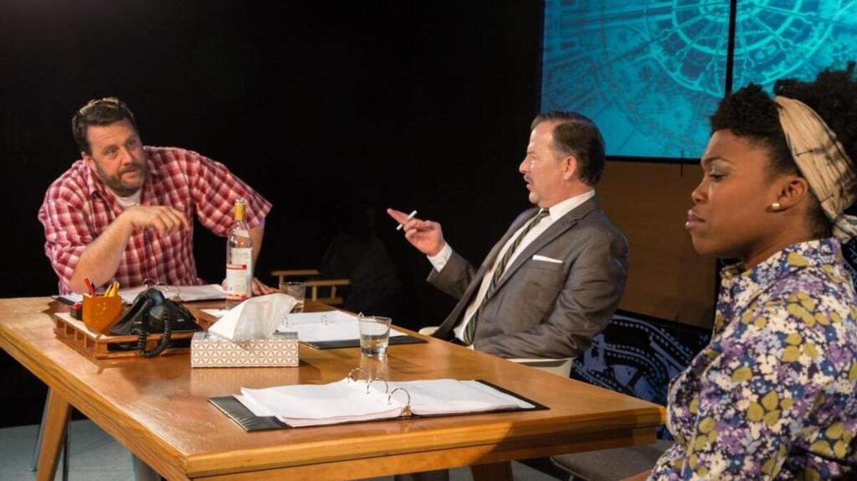 Walt (Derrick Ivey), center, discusses discuss a transfer of power and offspring naming rights with his son-in-law Ray (David Berberian), left, and his Daughter (Lakeisha Coffey), right, in Manbites Dog Theater and Street Signs production of “A Public Reading of an Unpublished Screenplay About the Death of Walt Disney.”