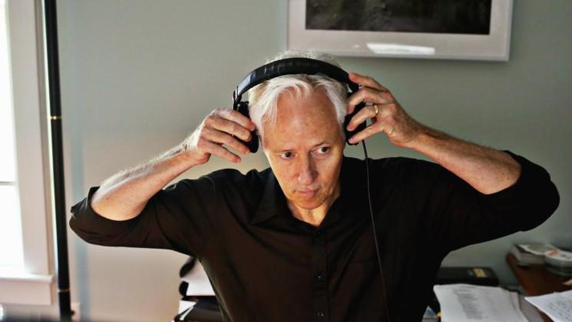 John Biewen, the host of the Scene on Radio podcast, adjusts his headphones as he edits the latest episode in his office at Center for Documentary Studies at Duke in Durham on Wednesday, Aug. 24, 2017.