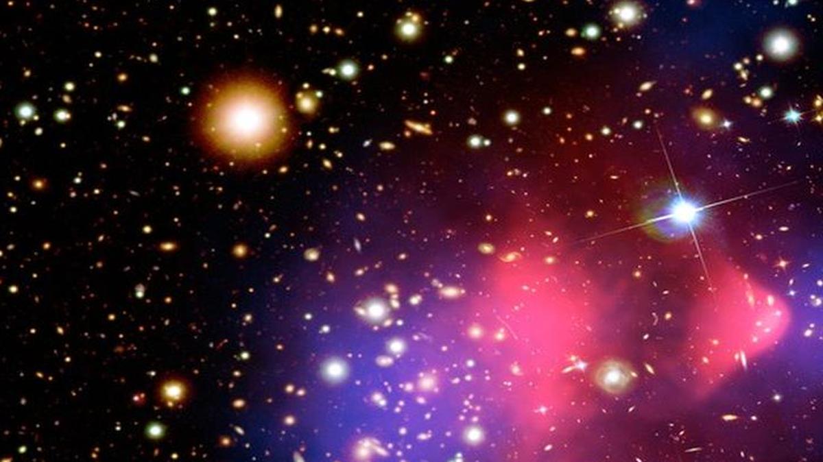 
This composite image shows the galaxy cluster 1E 0657-56, also known as the "bullet cluster", formed after the collision of two large clusters of galaxies. Hot gas detected by Chandra is seen as two pink clumps in the image and contains most of the "normal" matter in the two clusters. An optical image from Magellan and the Hubble Space Telescope shows galaxies in orange and white. The blue clumps show where most of the mass in the clusters is found, using a technique known as gravitational lensing. Most of the matter in the clusters (blue) is clearly separate from the normal matter (pink), giving direct evidence that nearly all of the matter in the clusters is dark. This result cannot be explained by modifying the laws of gravity.
