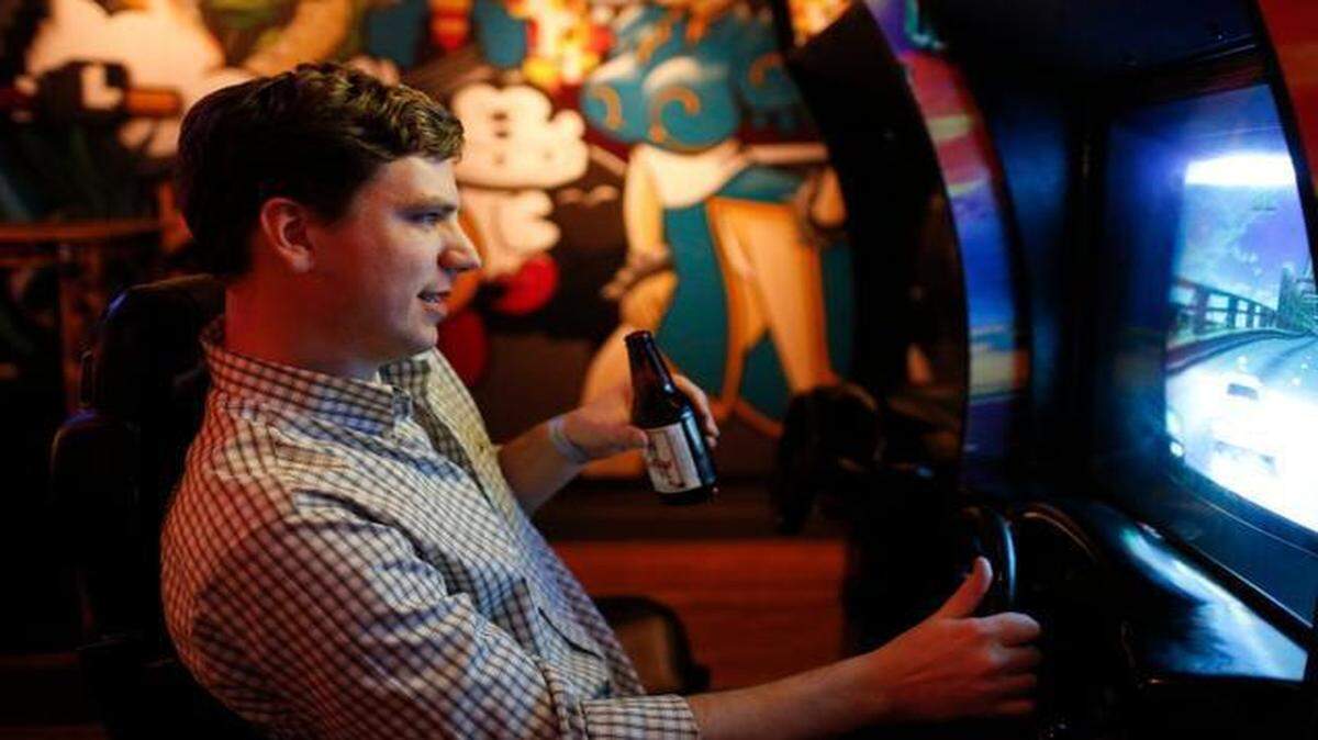 
Garret Stegeland plays a driving game at Level Up Kitchen + Barcadium in Raleigh. 
