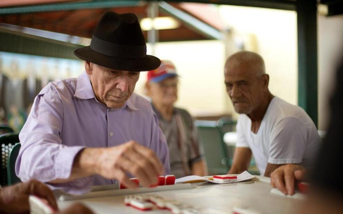 
 In this May 2, 2014, file photo, men play dominoes on Calle Ocho (Eighth Street) in Miami's Little Havana. 
