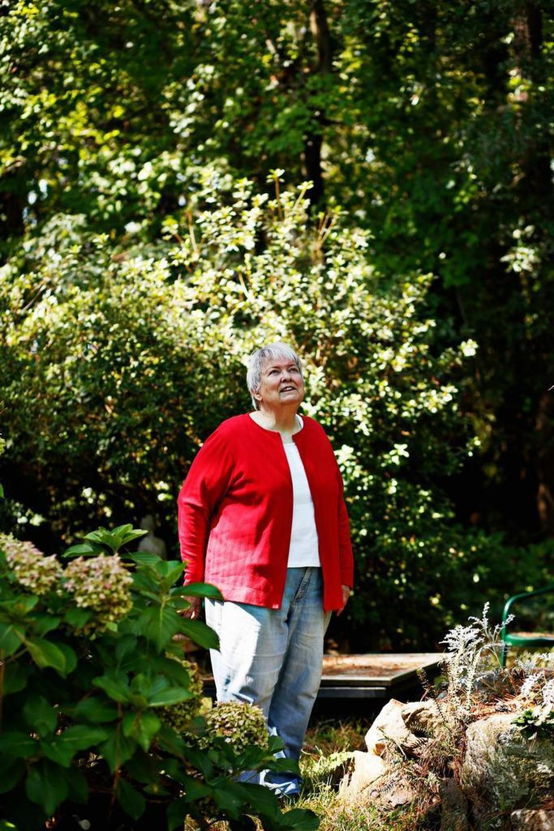 Mystery writer Margaret Maron is encircled by a grouping of stones gathered from her grandparents’ home at her family farm in Johnston County on Sept. 14, 2016.