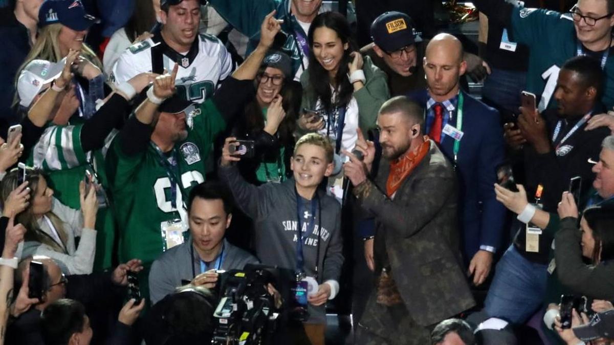 Thirteen-year-old Ryan McKenna takes a selfie as Justin Timberlake performs during halftime of the NFL Super Bowl 52 football game Sunday, Feb. 4, 2018, in Minneapolis.