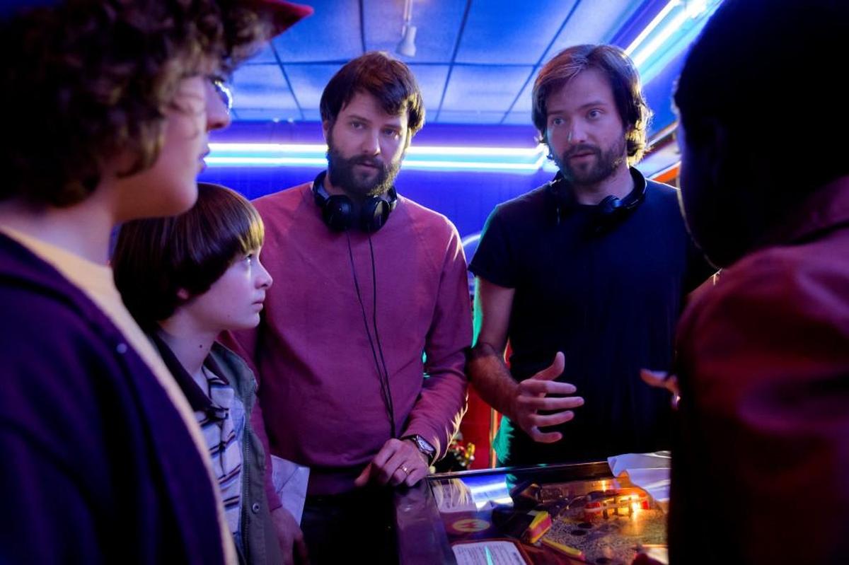 Gaten Matarazzo, Noah Schnapp, Ross Duffer, Matt Duffer and Caleb McLaughlin on the set of “Stranger Things.”