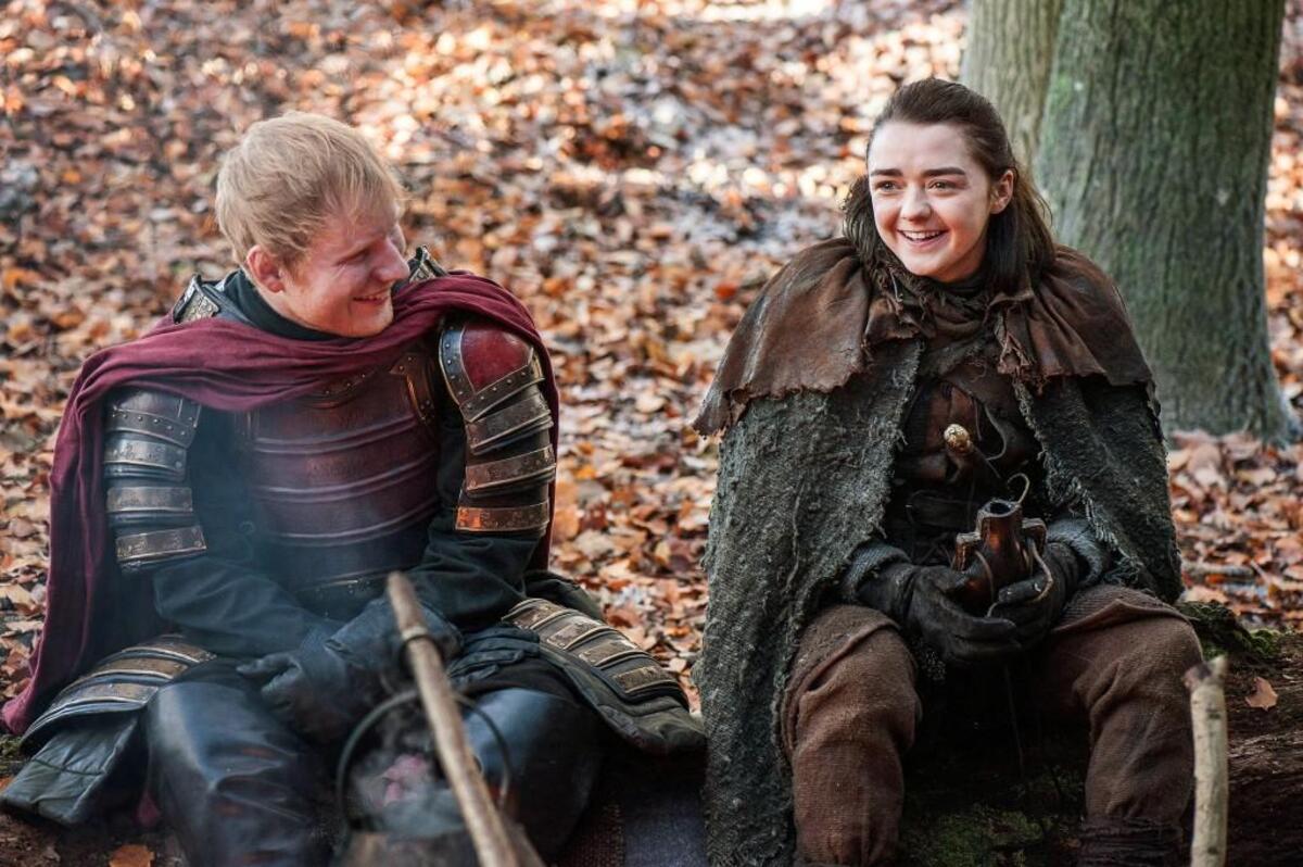 Ed Sheeran, left, and Maisie Williams in a scene from “Game of Thrones.” Sheeran appeared as a Lannister soldier leading a group in song in the season premiere of the hit HBO fantasy drama.