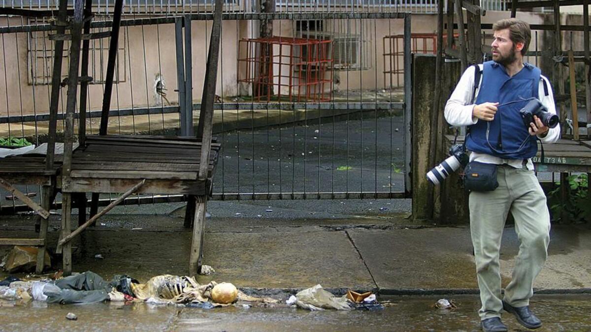 Chris Hondros with his cameras in Liberia in 2003