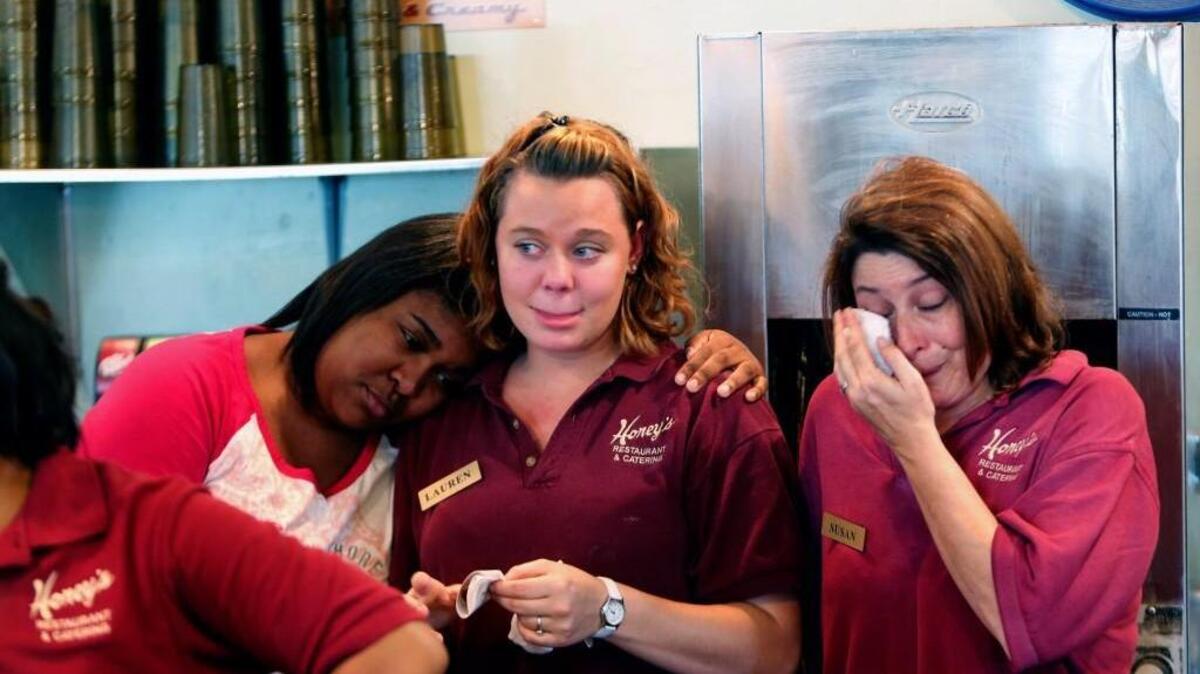 Employees from left, Fabienne Sewell, Lauren Emorey and Susan Perry become emotional after Honey’s Restaurant and Catering, a 24-hour diner in Durham, closed its doors for the last time in 2013 after serving the Bull City for more than 50 years.