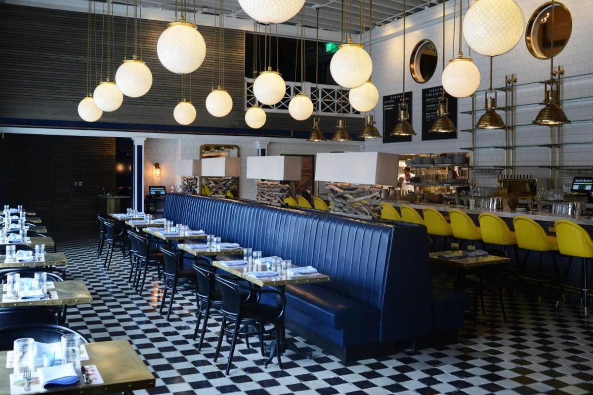 The former Fishmonger’s restaurant in Durham has been transformed into Saint James, a seafood palace with porthole doors of polished brass and a marble bar with more than a dozen bright yellow high top chairs. There’s also an upstairs “Captain’s Quarters” for private dining, complete with giant wooden chandeliers and paintings on the wall devoted to the sea.