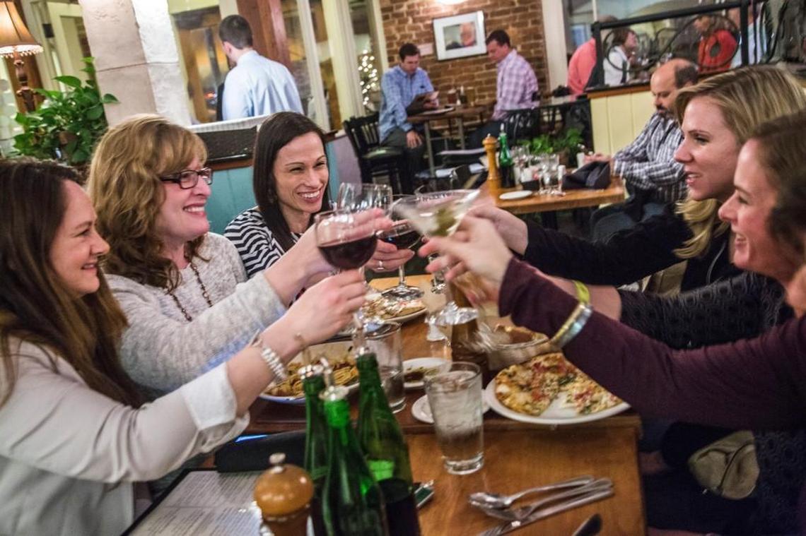 Friends clockwise from left, Anita Blomme Pinther, Holly Durham, Christina Korman Celestini, Paige Roberts, Suzanne Bio and Angela Risko make a toast to the closing of one of their favorite restaurants Wednesday, April 1, 2015 at 518 West in Raleigh . The popular restaurant closed it's doors Easter Sunday after 18 years serving Italian food.