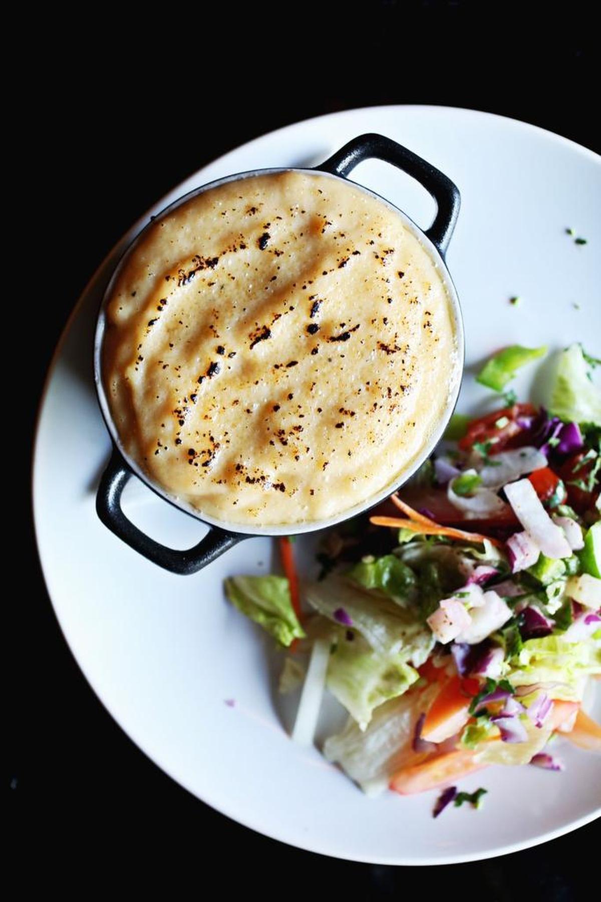 Curried Shepherd’s Pie - ground lamb, peas and carrots in a mild curry-spiced gravy, baked under a mashed potato crust - is a delightful example of combining British and Indian cuisines.