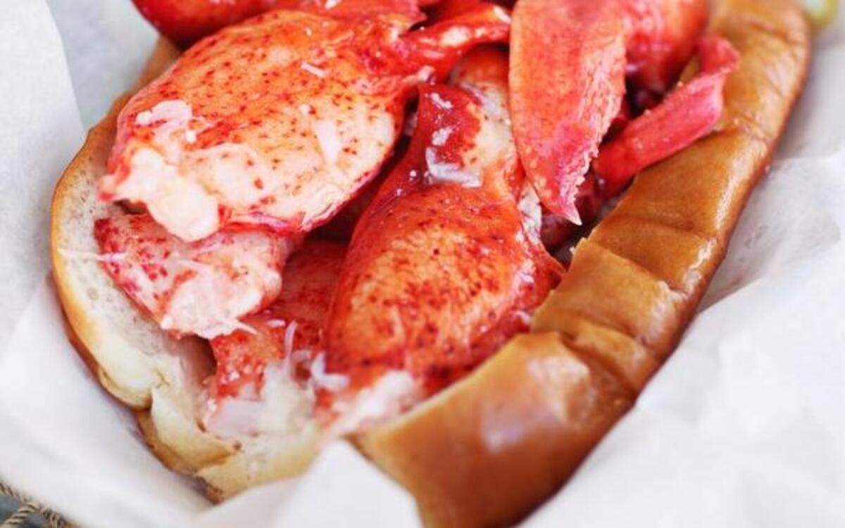 The classic Maine lobster roll from Cousins Maine Lobster truck delivers chunks of chilled sweet lobster meat in such abundance that you can barely see the buttered and toasted New England style top-split hot dog roll it's served on.