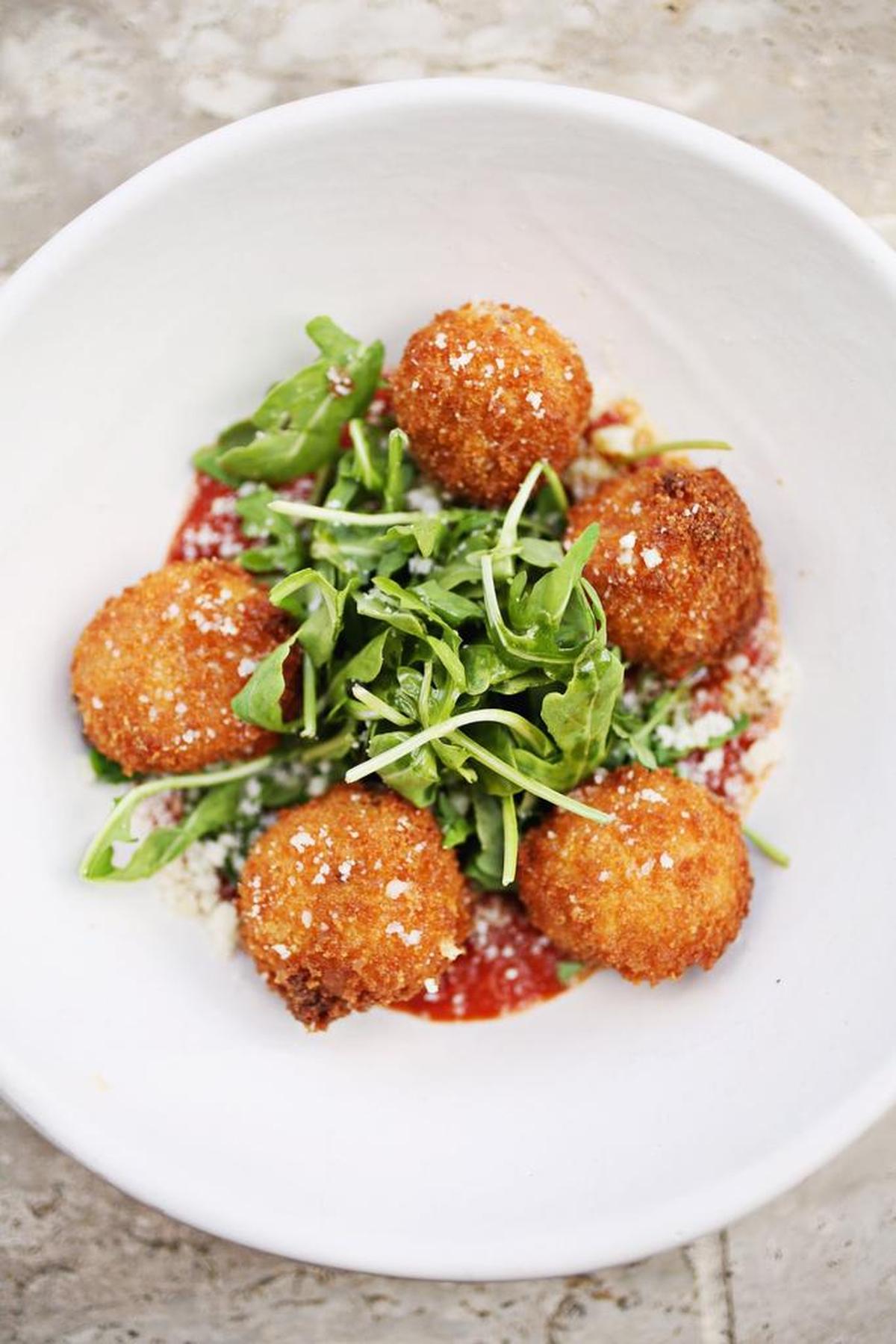The Arancini, deep-fried rice balls with a beef ragu plays a toothsome counterpoint to their fresh mozzarella creaminess, at Mulino in Raleigh.