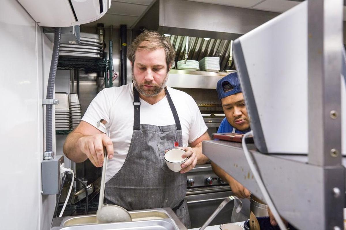 Chef Matt Kelly tastes soup as everyone prepares to open for dinner at Saint James Seafood on Thursday, Mar. 14, 2018, in Durham, NC.