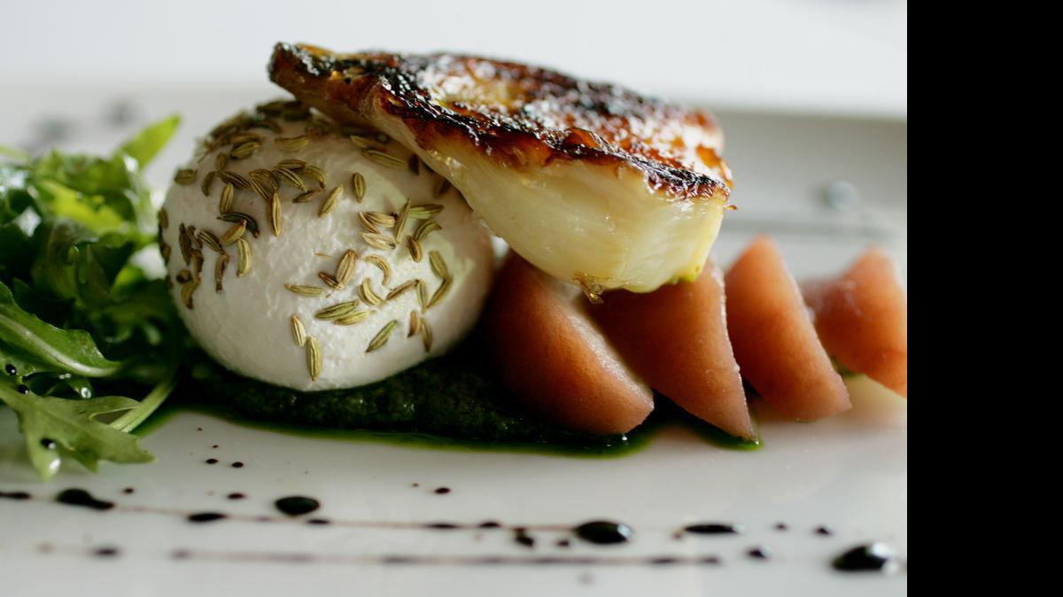 
Caramelized fennel and local goat cheese salad is served with poached apple and arugula pesto at Midtown Grille in Raleigh. JULI LEONARD - jleonard@nando.com
