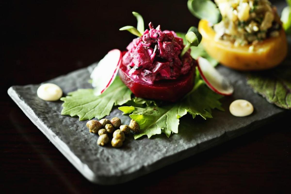 Colombian Remolachas Rellenas made up of braised beets stuffed with a colorful hash of chopped hardboiled local egg, capers and cilantro stand out like jewels on the slate plates they are served upon at so.ca.