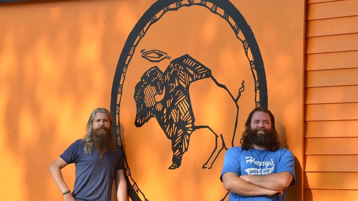 Mark Dundas, left, and business partner, Dain Phelan in front of their brightly colored chicken wing restaurant Heavenly Buffaloes in 2014. A Chapel Hill location of Heavenly Buffaloes will open on Franklin Street April 5, 2018.