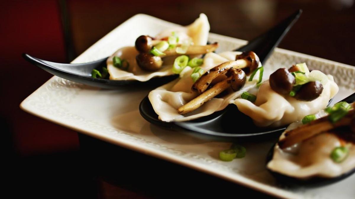 The tom yum dumplings at Bua Thai Cuisine in Durham are a work of modern art - each one a plump, puckered pillow of pristine white, nestled in a sleek black ceramic spoon topped with tiny straw mushrooms and chopped scallions.