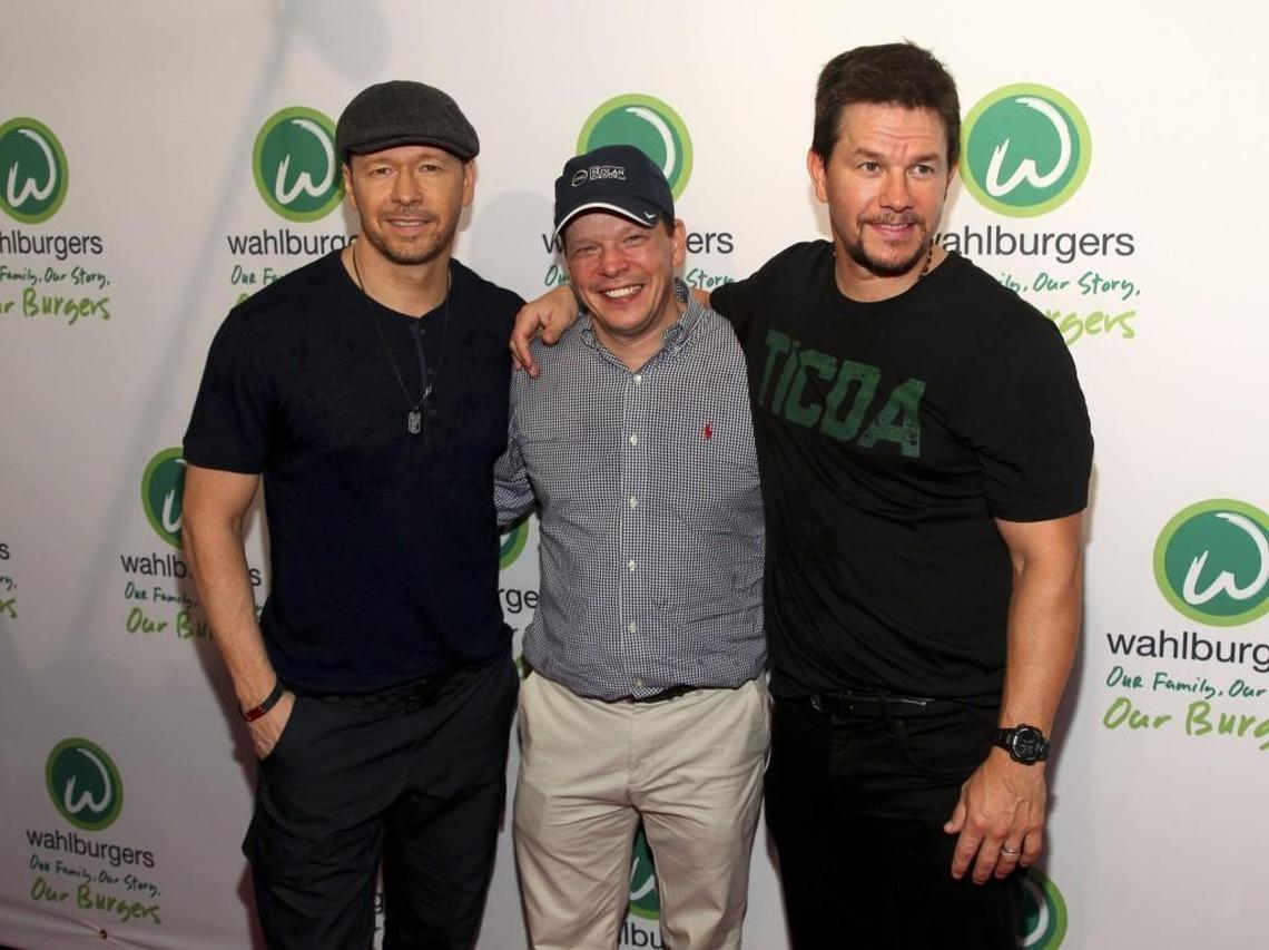 Donnie Wahlberg, from left, Paul Wahlberg and Mark Wahlberg attend the Wahlburgers Coney Island preview party in New York June 23, 2015. It's unclear whether any Wahlberg family member will visit the new Raleigh restaurant.