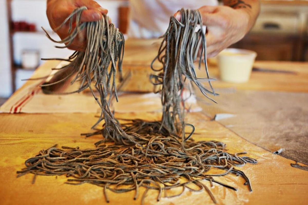 Mothers & Sons owner and chef Josh DeCarolis makes homemade tonnarelli at the Durham restaurant in 2016. DeCarolis makes all the pasta by hand daily on the large family style dining table at the back of the restaurant before service.