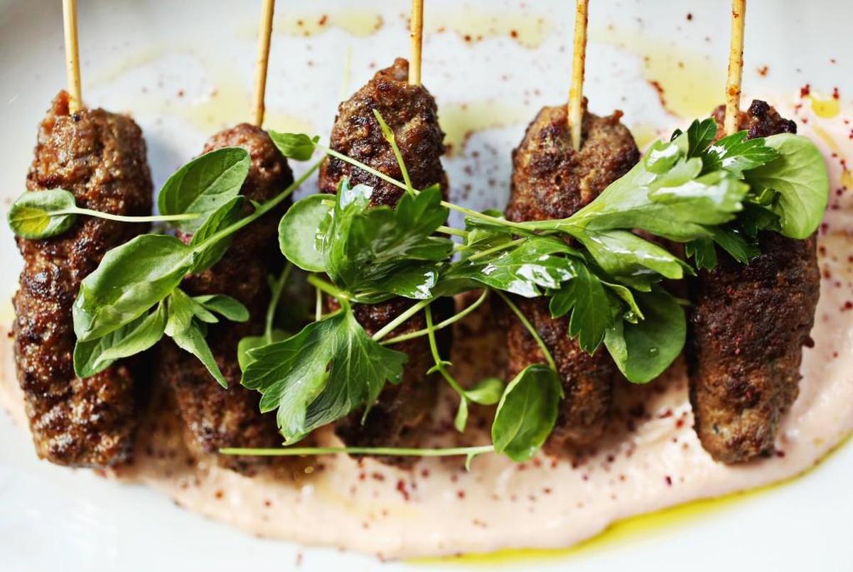 Moroccan beef skewers, served with a harissa-spiced Greek yogurt, are a deservedly popular small plate offering at Vidrio in Raleigh.