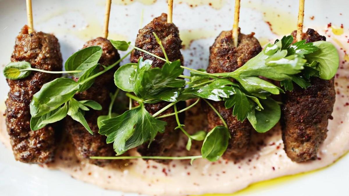 Moroccan beef skewers, served with a harissa-spiced Greek yogurt, are a deservedly popular small plate offering at Vidrio in Raleigh.