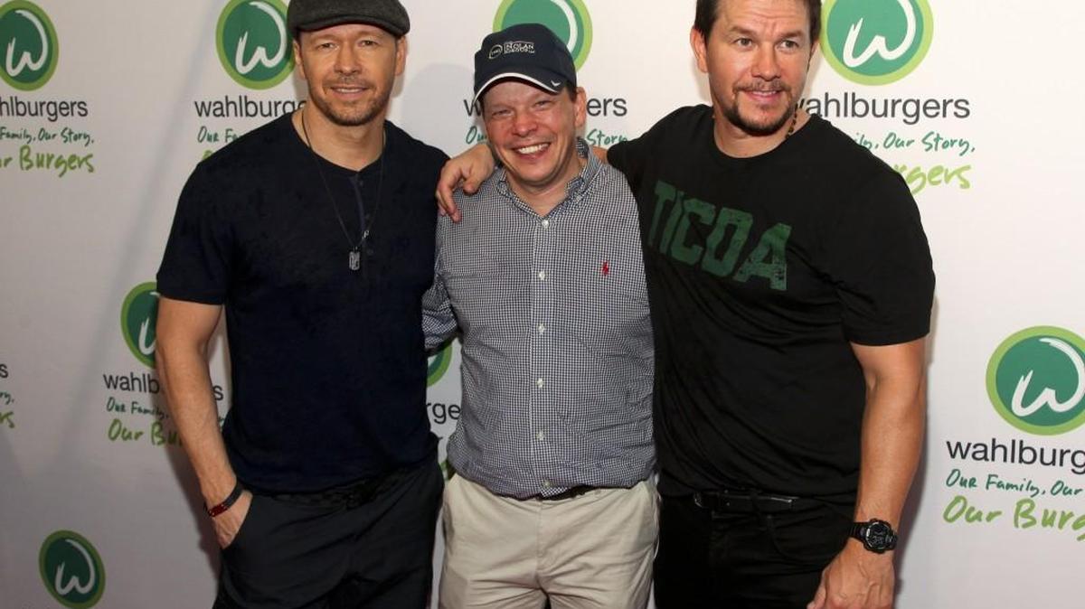 Donnie Wahlberg, from left, Paul Wahlberg and Mark Wahlberg attend the Wahlburgers Coney Island preview party in New York June 23, 2015. It's unclear whether any Wahlberg family member will visit the new Raleigh restaurant.