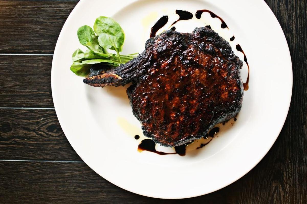 The porcini-rubbed bone-in ribeye with 15-year-aged balsamic is the signature steak at The Capital Grille in Raleigh.