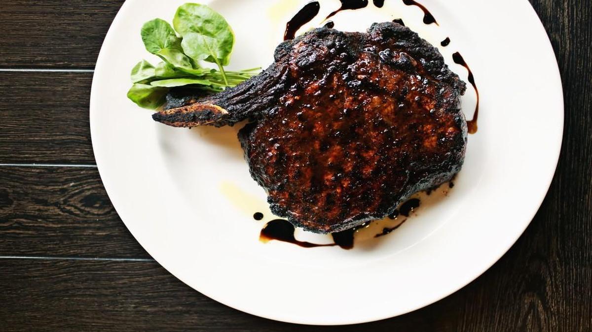 The porcini-rubbed bone-in ribeye with 15-year-aged balsamic is the signature steak at The Capital Grille in Raleigh.