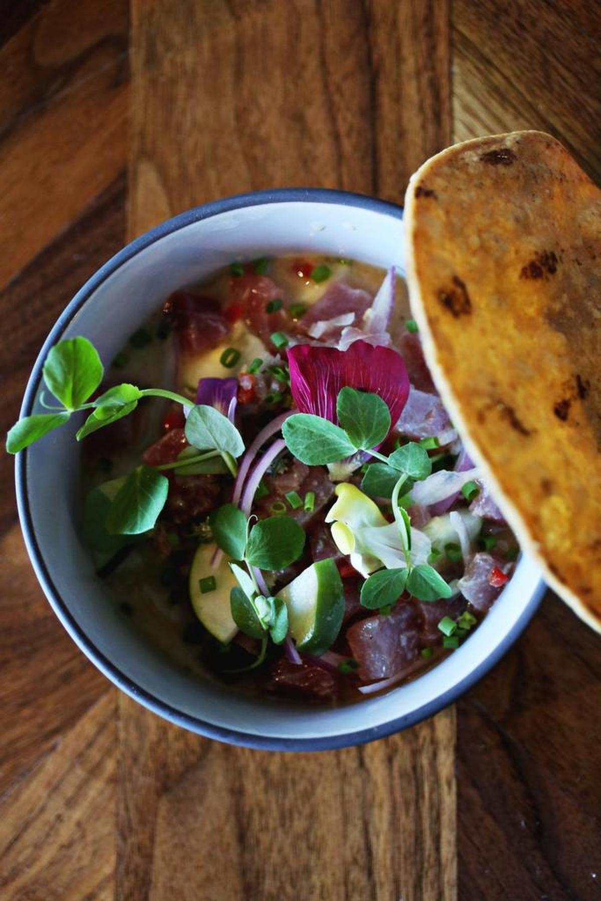The Tiger Style Ceviche is made up of NC tuna, red onion, toasted Carolina corn nuts , farmer’s market aji, onion ash and cold seafood Leche De Tigre broth at The Cortez in Raleigh.